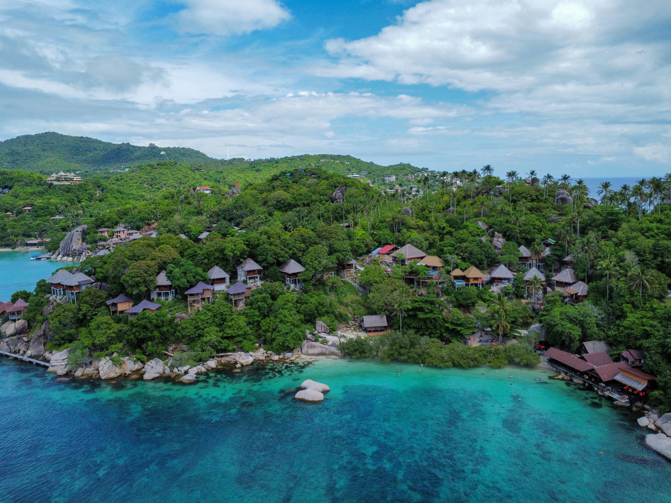 Panoramisch uitzicht over een groene baai met houten bungalows aan de kust van Koh Tao Thailand